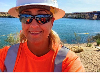 Pictured: Patty Anaya, Project Manager at Cascade Environmental, wearing a hard hat and sunglasses on a project site