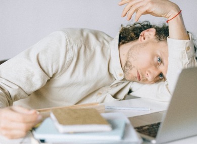 An overworked employee in front of his computer